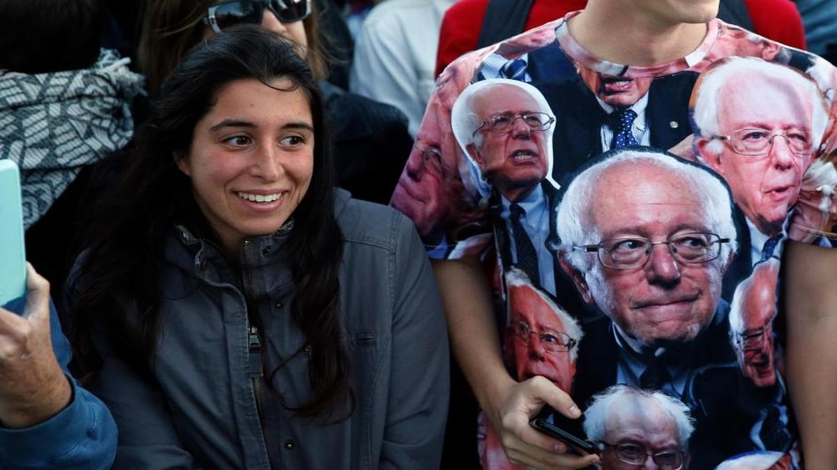 Supporters smile at the arrival of independent Vermont Sen. Bernie Sanders to speak at a rally in support of Colorado Amendment 69, a ballot measure to set up the nation's first universal health-care system, on campus of the University of Colorado, in Boulder, Colo., Oct. 17, 2016. Amendment 69 would repeal the current health insurance system and make coverage universal.