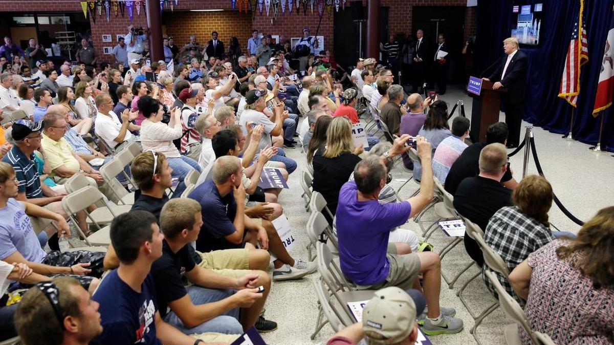 
Donald Trump speaks to an overflow crowd following a rally and picnic in Iowa. He and Democrat Bernie Sanders have drawn big crowds this summer, often voters frustrated with Washington.
