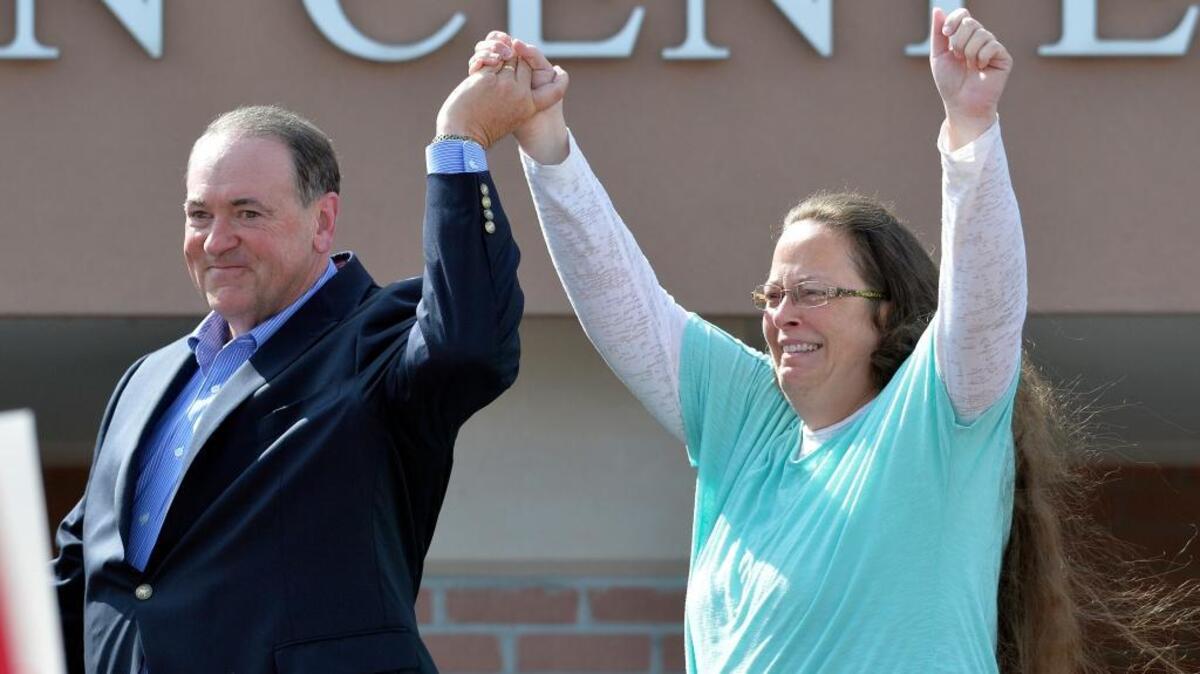 Rowan County Clerk Kim Davis, with Republican presidential candidate Mike Huckabee at her side, greets the crowd after being released from the Carter County Detention Center, in Grayson, Kentucky on Sept. 8.