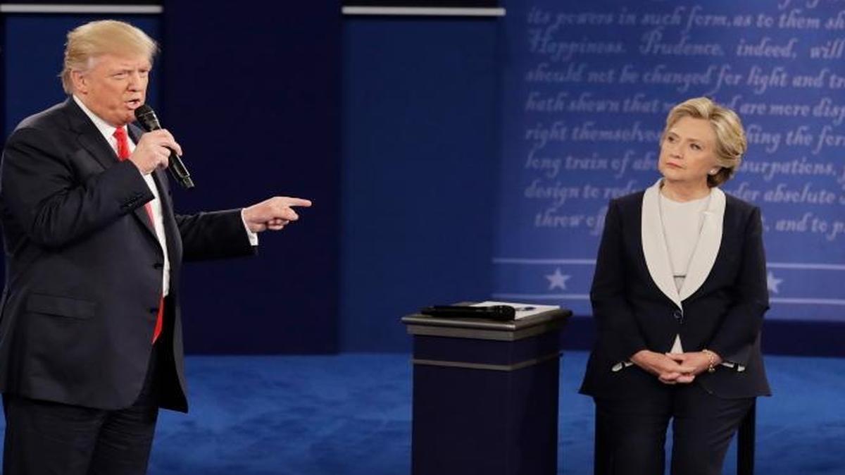 Democratic presidential nominee Hillary Clinton listens to Republican presidential nominee Donald Trump during the second presidential debate at Washington University, Sunday, Oct. 9, 2016, in St. Louis.