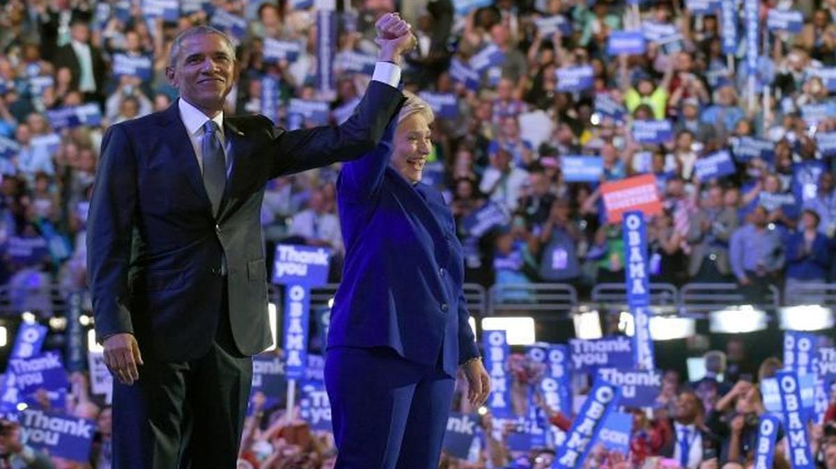 President Barack Obama, right, and Democratic presidential candidate Hillary Clinton, left, wave to the crowd following Obama's speech at the Democratic National Convention in Philadelphia, July 27, 2016.
