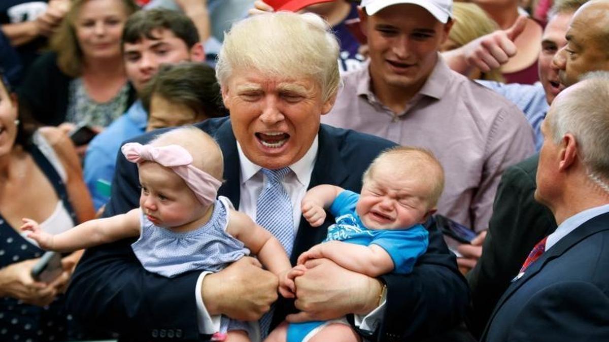Republican presidential candidate Donald Trump holds Kellen Campbell of Denver, right, and Evelyn Keane, of Castle Rock, Colo. during a campaign rally, Friday, July 29, 2016, in Colorado Springs, Colo.