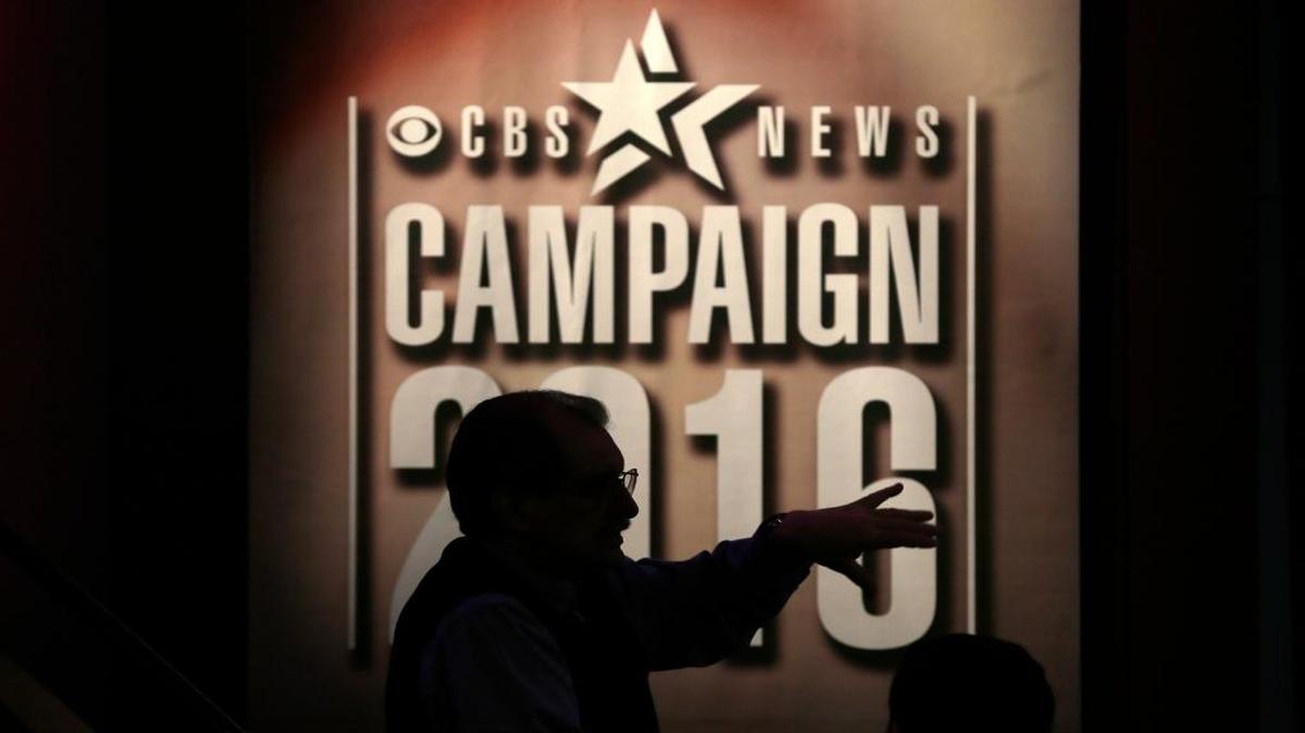 A worker talks to a member of the media on the stage in the Sheslow Auditorium on Drake University campus before a Democratic presidential primary debate, Saturday, Nov. 14, 2015, in Des Moines, Iowa.