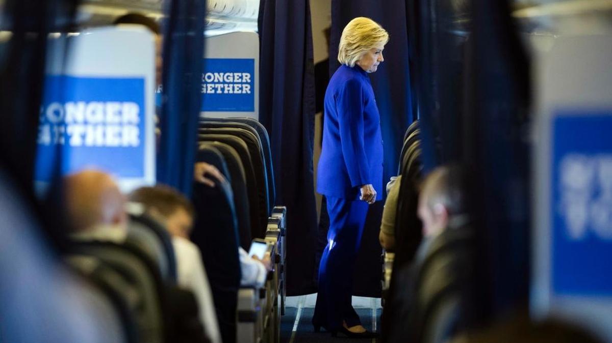 Democratic presidential candidate Hillary Clinton meets with members of her staff onboard her campaign plane en route to Westchester County Airport in White Plains, N.Y.