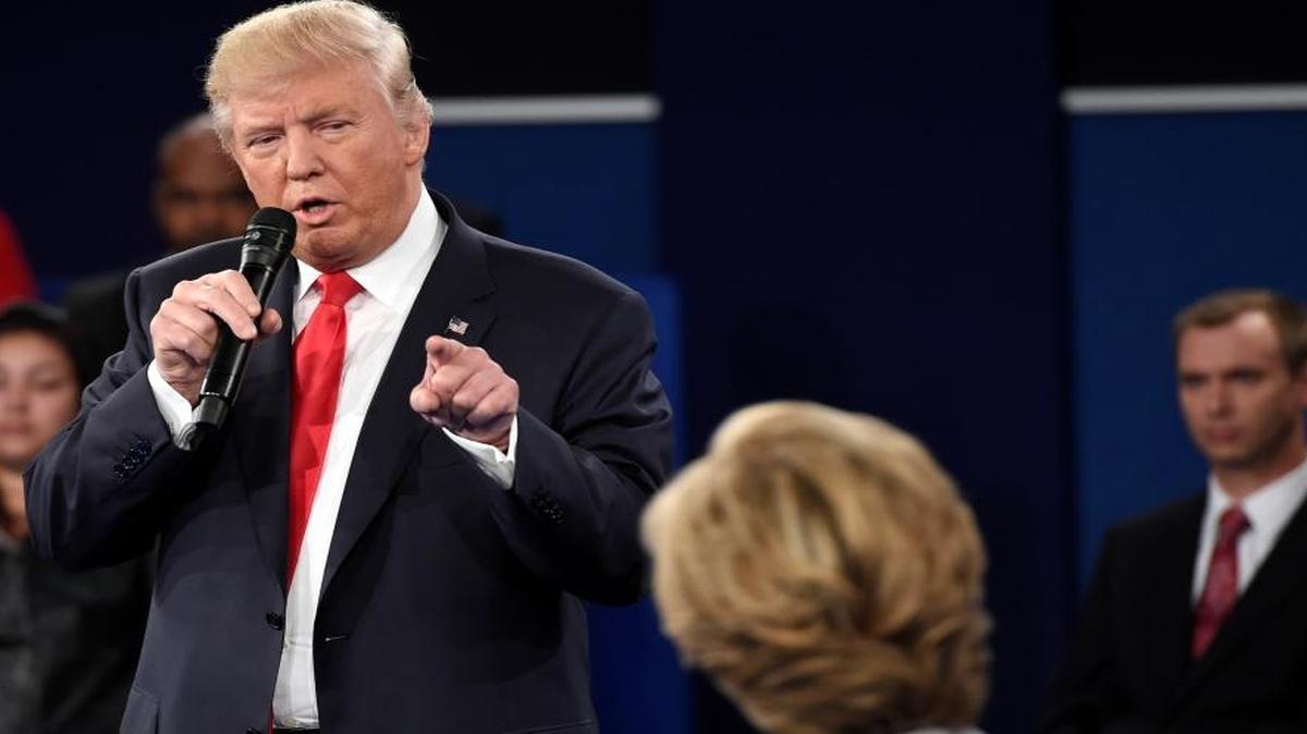 Republican presidential nominee Donald Trump points at Democratic presidential nominee Hillary Clinton as he speaks during the second presidential debate at Washington University in St. Louis, Sunday, Oct. 9, 2016.