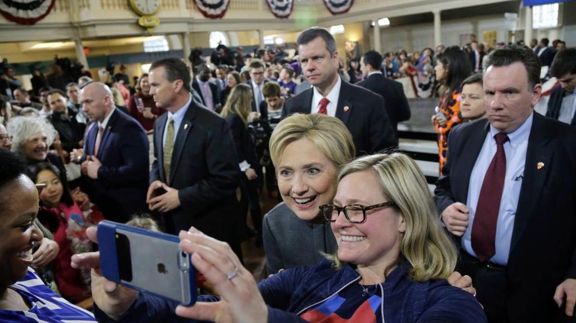 Democratic presidential candidate Hillary Clinton is surrounded by security as she poses for a photo with a supporter at a campaign event at the Old South Meeting House, Monday, Feb. 29, 2016, in Boston.