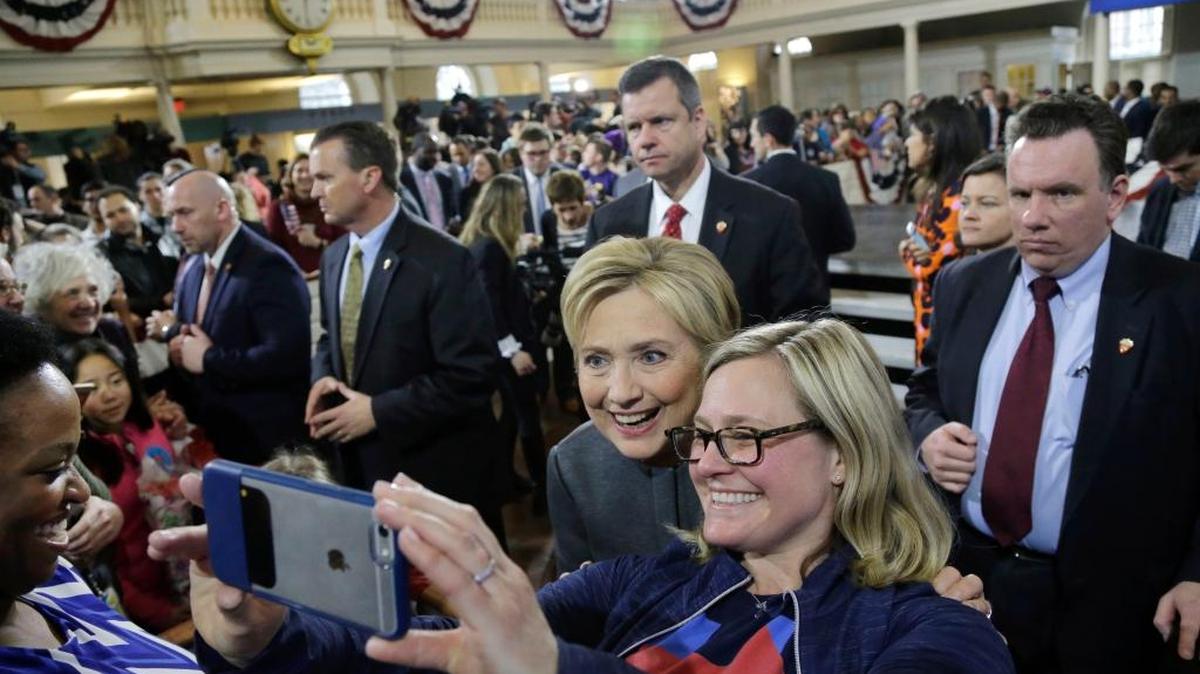 Democratic presidential candidate Hillary Clinton is surrounded by security as she poses for a photo with a supporter at a campaign event at the Old South Meeting House, Monday, Feb. 29, 2016, in Boston.