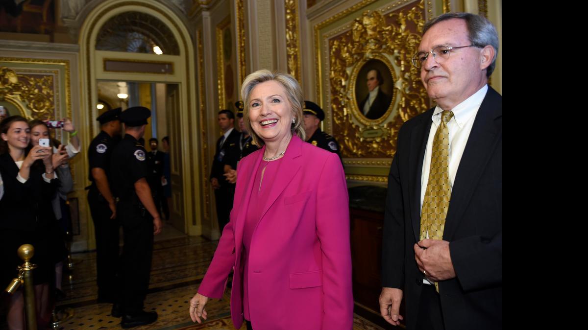 
Democratic presidential candidate Hillary Rodham Clinton, center, walks with David McCallum, Deputy Chief of Staff for Senate Minority Leader Sen. Harry Reid of Nev., right, as they arrive for the weekly policy luncheon with Senate Democrats on Capitol Hill in Washington, Tuesday, July 14, 2015. 
