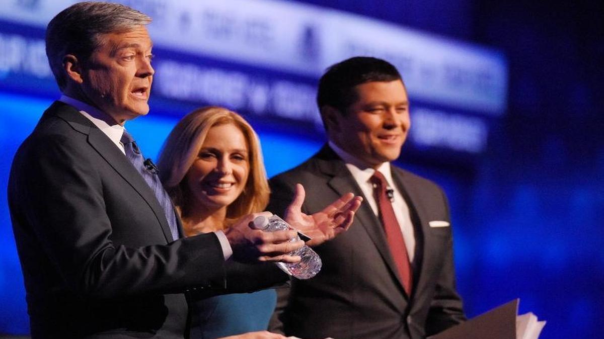 Debate moderators John Harwood, left, Becky Quick, center, and Carl Quintanilla take the stage during the CNBC Republican presidential debate at the University of Colorado, Wednesday, Oct. 28, 2015, in Boulder, Colo.