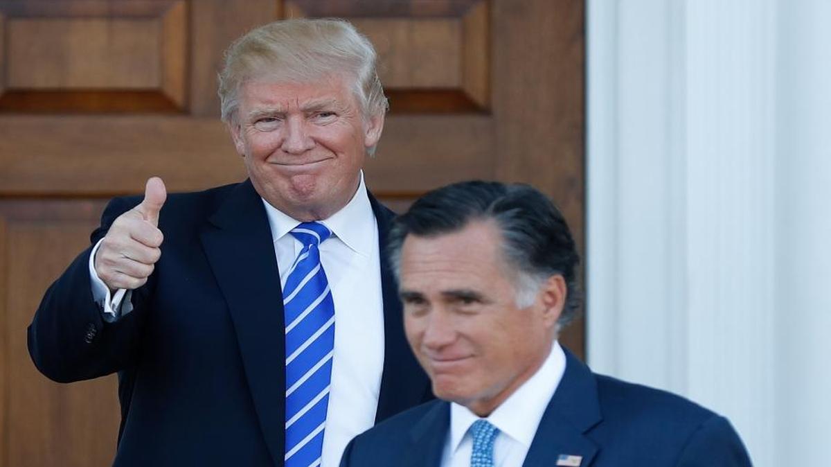 President-elect Donald Trump gives the thumbs-up as Mitt Romney leaves Trump National Golf Club Bedminster in Bedminster, N.J., Saturday, Nov. 19, 2016.