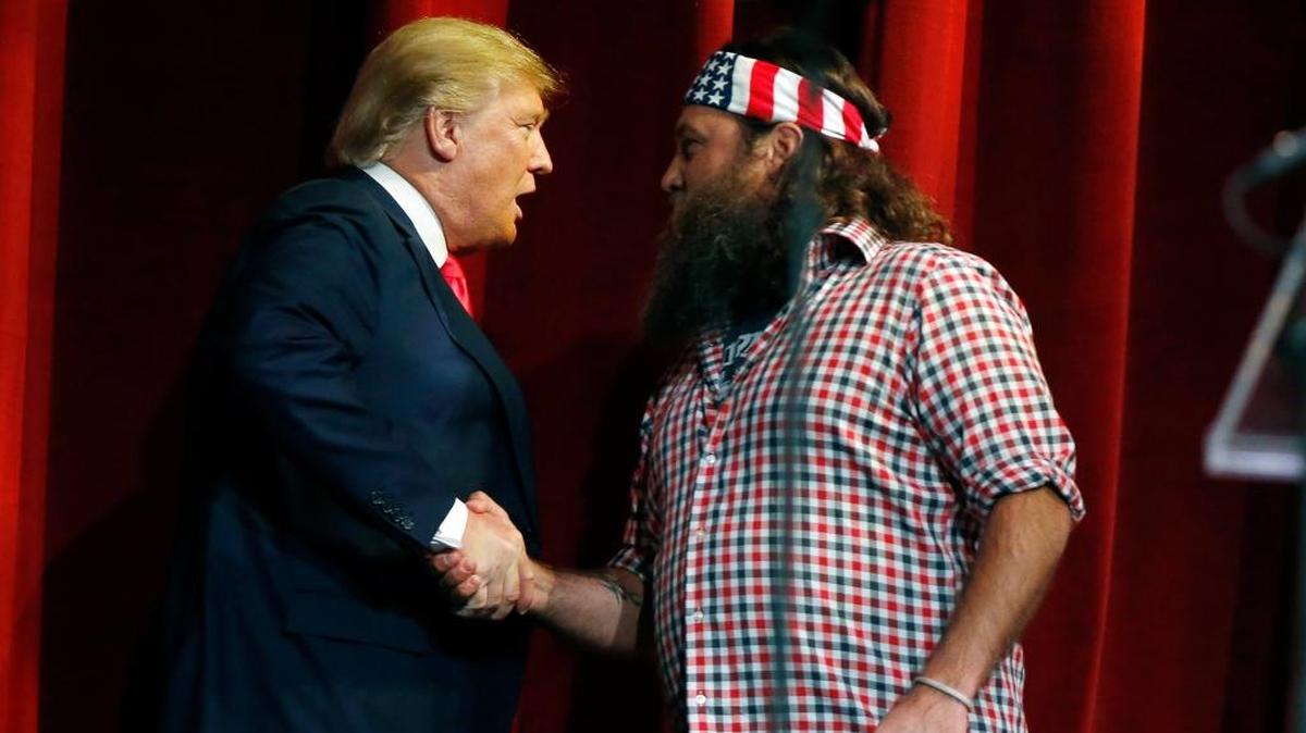 Willie Robertson, right, welcomes Republican presidential candidate Donald Trump to the stage during the Outdoor Channel and Sportsman Channel's 16th annual Outdoor Sportsman Awards on Thursday, Jan. 21, 2016, in Las Vegas.