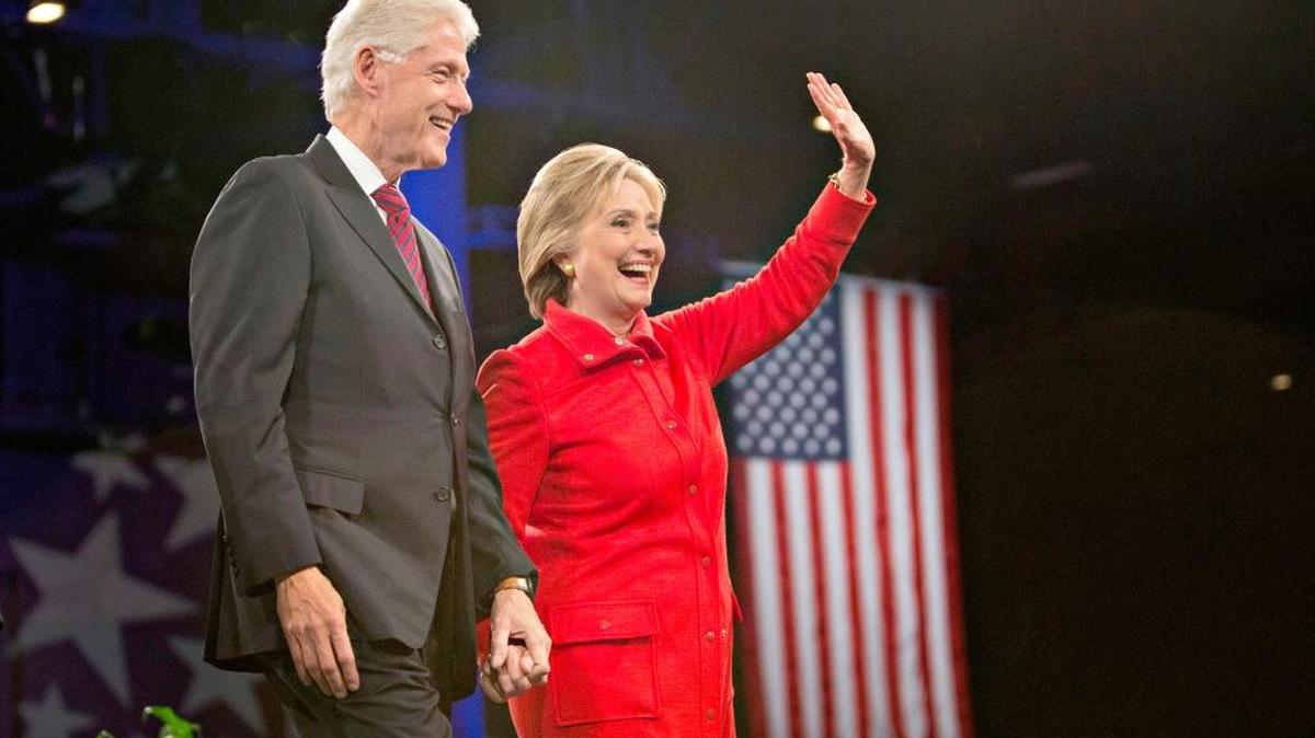 Hillary Clinton stands on stage with her husband, former President Bill Clinton, at the conclusion of the Jefferson-Jackson Dinner in Des Moines, Iowa on Saturday. Clinton and her rival for the Democratic nomination, Sen. Bernie Sanders of Vermont, have very different recollections of how the law that prohibited federal recognition of same-sex marriage came about.