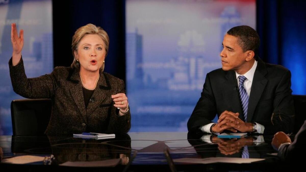 Then-Sen. Hillary Clinton, D-N.Y., left, and then-Sen. Barack Obama, D-Ill., participate in a Democratic presidential debate in Cleveland eight years ago.