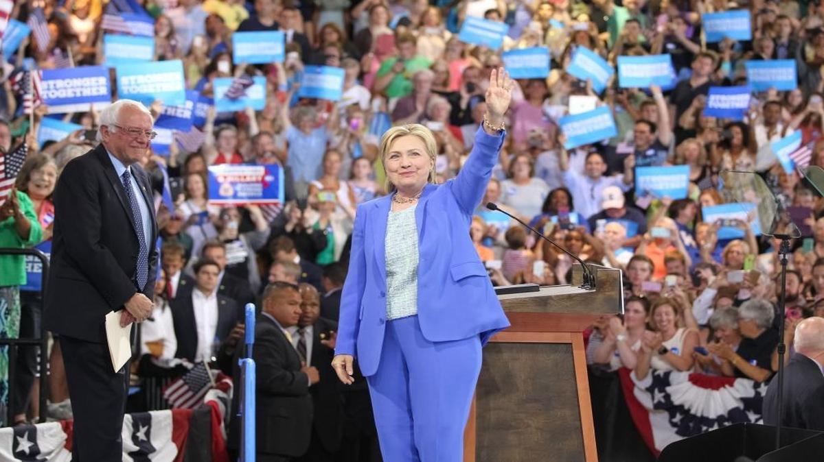 Hillary Clinton greets the crowd along with Sen. Bernie Sanders during an event where he endorsed her at a Portsmouth, N.H., high school rally in July. A new Harvard poll of millennials shows that Clinton is starting to gain some support from the young voters who backed Sanders’ presidential campaign.