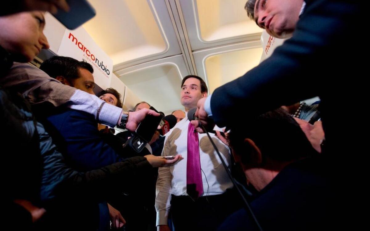 Republican presidential candidate Marco Rubio listens to a question from the traveling media on board his plane en route from New Hampshire to South Carolina on Wednesday.