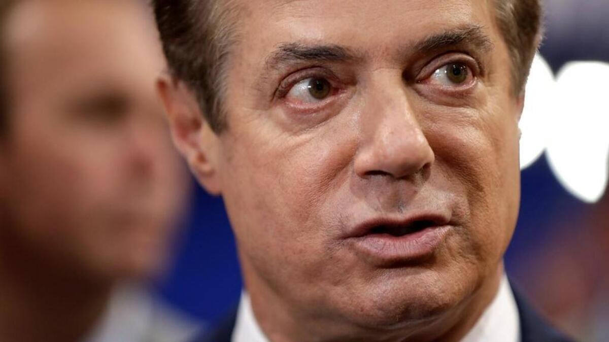 Trump Campaign Chairman Paul Manafort talks to reporters on the floor of the Republican National Convention at Quicken Loans Arena.