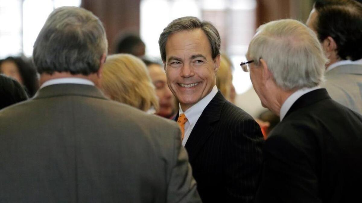 Texas Speaker of the House Joe Strauss, center, talks to fellow lawmakers on the House floor on the final day of the legislative session, Monday, June 1, 2015, in Austin, Texas.