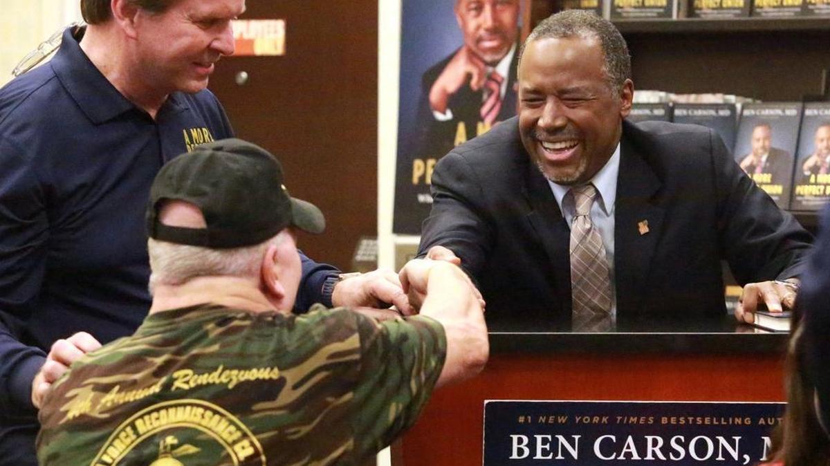 Republican presidential candidate Ben Carson shakes hands with a supporter during a book signing at the Lauderdale Barnes and Noble on Thursday.