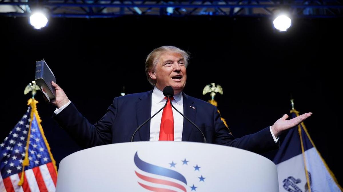 
Republican presidential candidate Donald Trump holds a Bible as he speaks at the Iowa Faith & Freedom Coalition's annual fall dinner on Saturday, Sept. 19, 2015, in Des Moines, Iowa.
