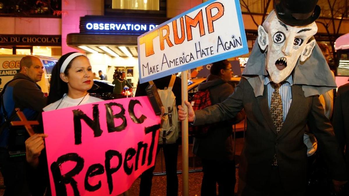 Protesters opposed to the appearance of Republican presidential candidate Donald Trump as a guest host on this weekend’s “Saturday Night Live” demonstrate in front of NBC Studios.
