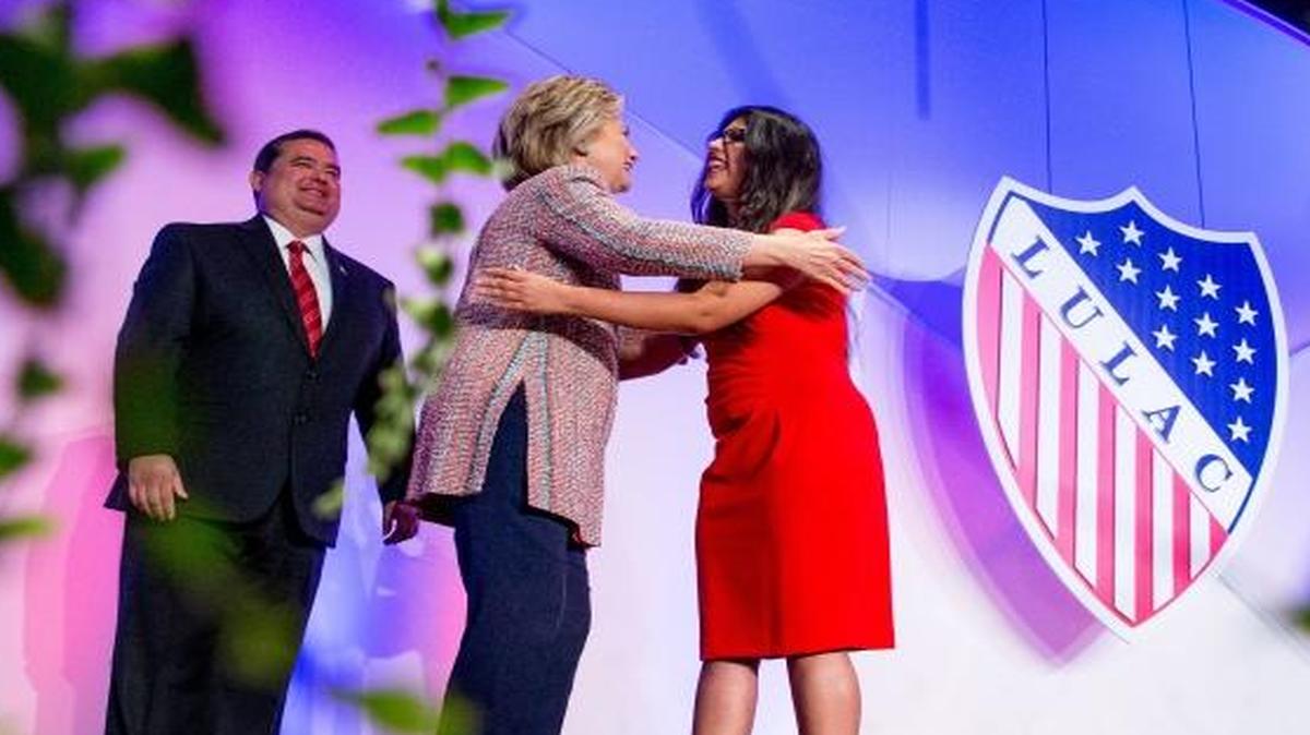 Democratic presidential candidate Hillary Clinton, accompanied by LULAC President Roger C. Rocha, Jr., hugs University of Texas student Dreamer Lizeth Urdiales at the 87th League of United Latin American Citizens National Convention at the Washington Hilton in Washington on Thursday.