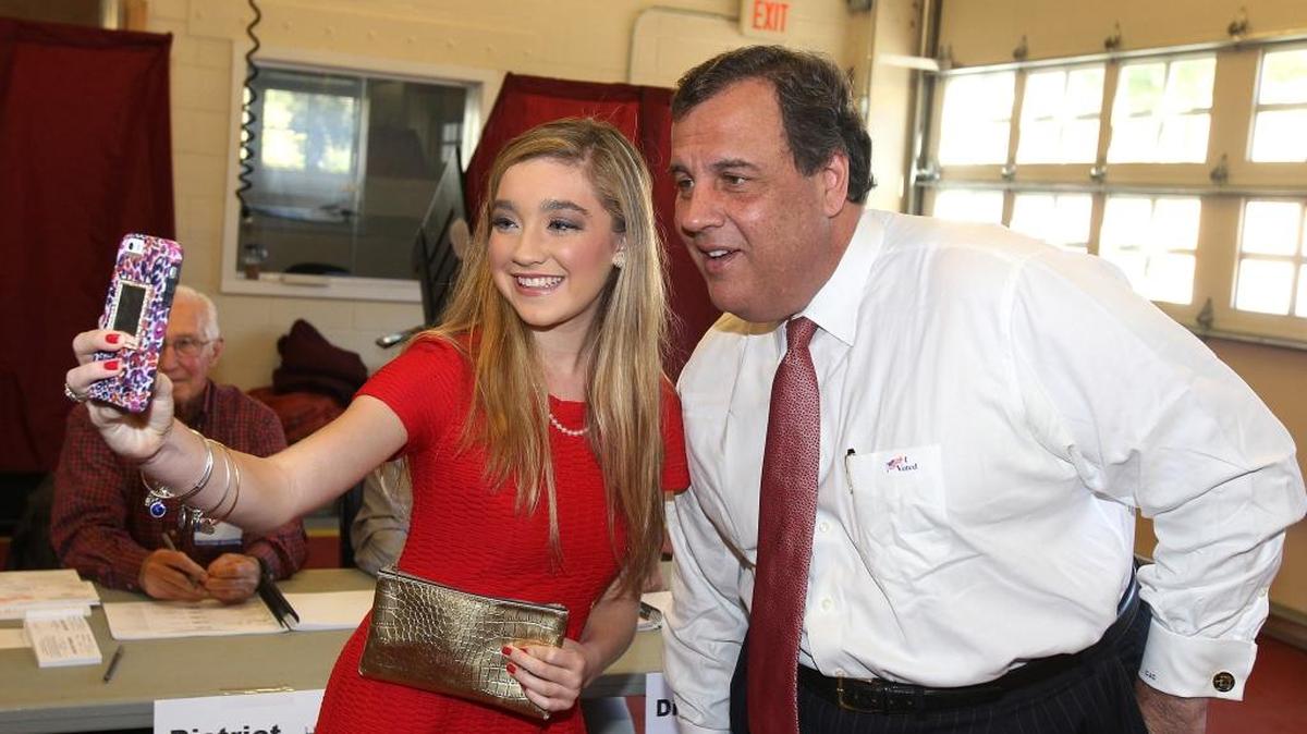 New Jersey Gov. Chris Christie poses for a photograph with Justine Brook Murray, 17, of Denville, NJ, after voting on Tuesday.
