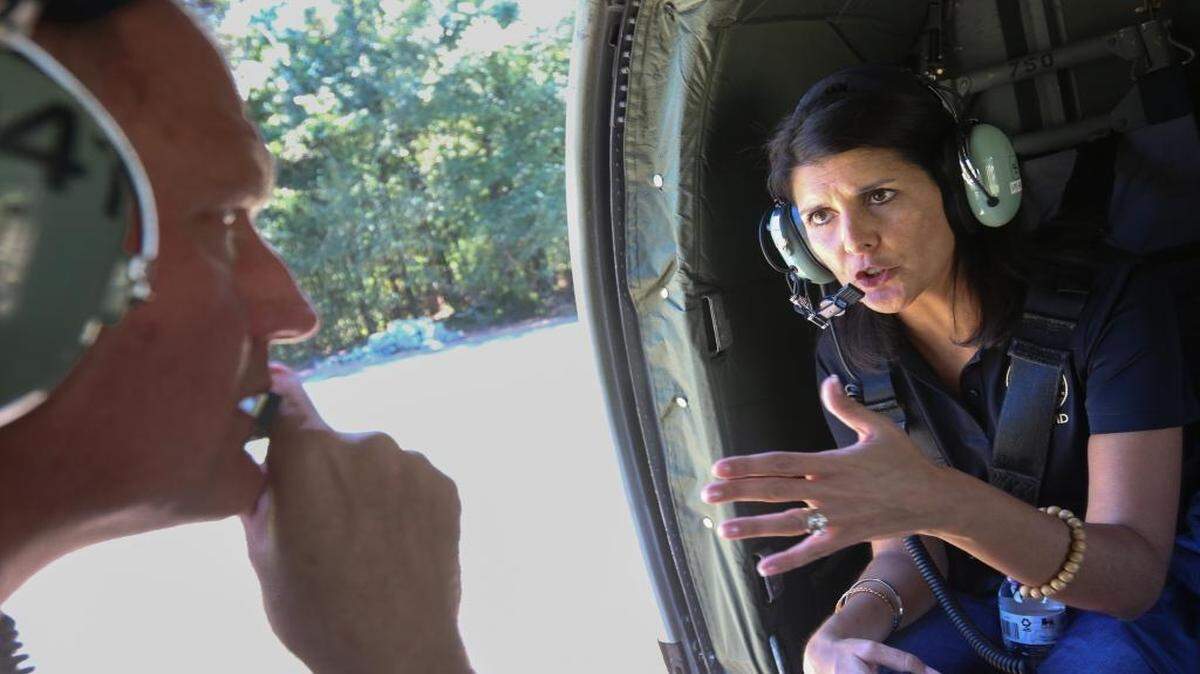 South Carolina Gov. Nikki Haley talks with Army Chief Warrant Officer 5 Kent Puffenbarger while assessing flood damage in Horry County last fall from an Army helicopter.