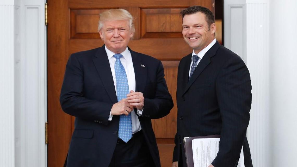 In this Nov. 20, 2016, file photo, Kansas Secretary of State Kris Kobach, right, holds a stack of papers as he meets with then President-elect Donald Trump in Bedminster, N.J. Kobach who is vice chairman of President Donald Trump’s commission on election fraud drafted a proposal for Trump to change federal voter registration laws.