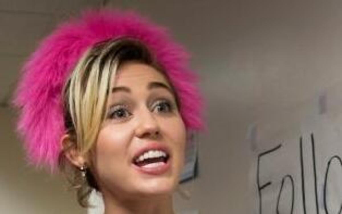 Miley Cyrus talks to students in a dorm while campaigning for democratic presidential nominee Hillary Clinton at George Mason University in Fairfax, Va. Saturday, Oct. 22, 2016.