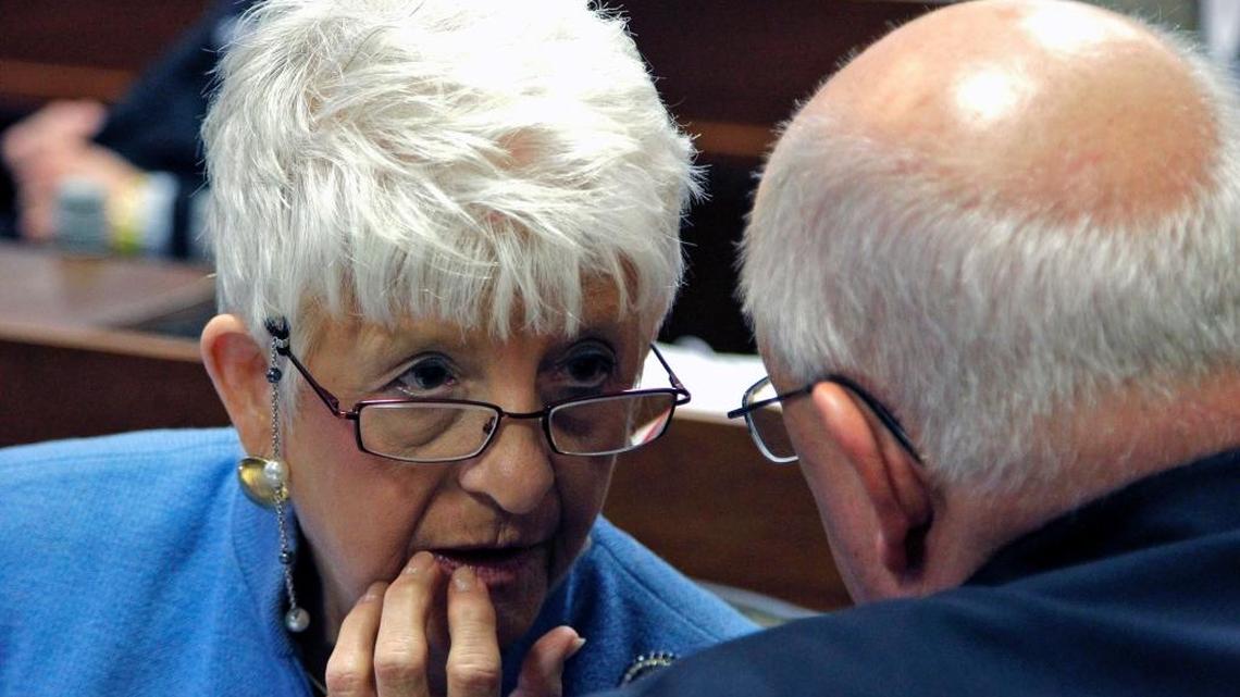 Rep. Julia Howard (R), left, talks to Rep. William Brawley (R), on the House floor during legislative session in Raleigh on July 31, 2014.