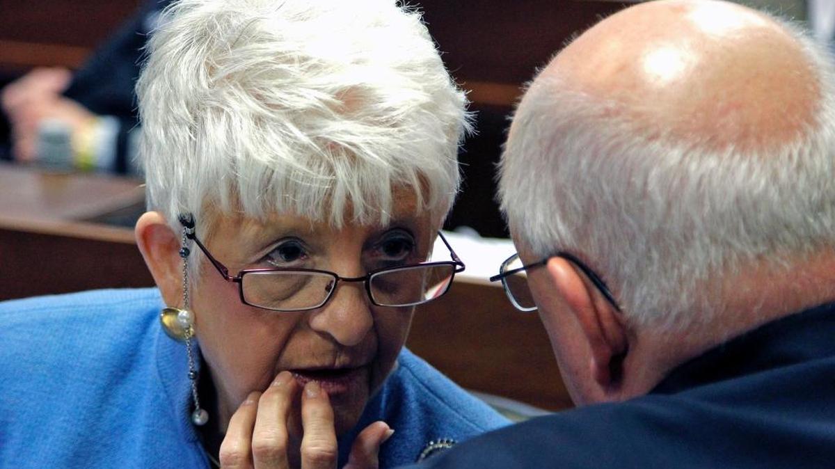 Rep. Julia Howard (R), left, talks to Rep. William Brawley (R), on the House floor during legislative session in Raleigh on July 31, 2014.