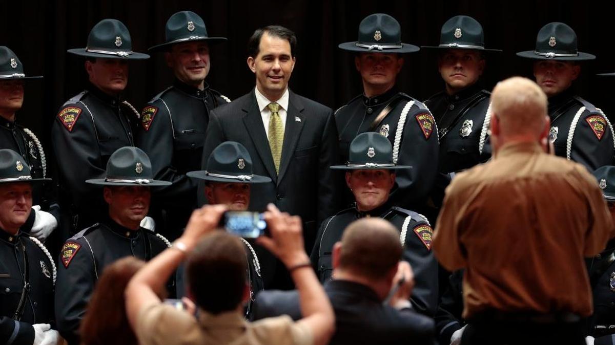 
Wisconsin Gov. Scott Walker poses for a picture with Wisconsin State Patrol Honor Guard members after an awards ceremony for the agency at Middleton, Wis.
