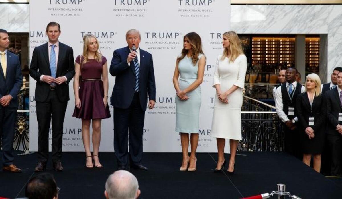 FILE - In this Oct. 26, 2016, file photo, Republican presidential candidate Donald Trump, accompanied by, from left, Donald Trump Jr., Eric Trump, Trump, Melania Trump, Tiffany Trump and Ivanka Trump, speaks during the grand opening of the Trump International Hotel- Old Post Office, in Washington. Donald Trumpâ€™s plan to hand control of his business to his children but hold onto ownership is drawing fire from government ethics experts. They say he should sell everything.