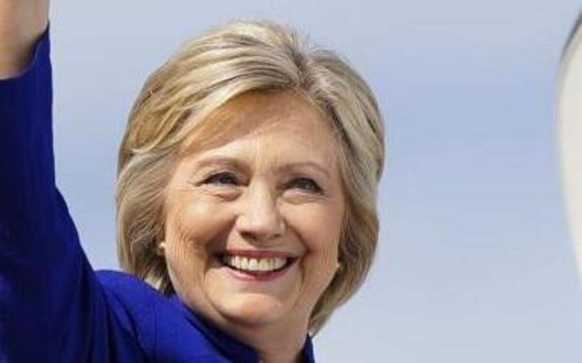 Democratic presidential candidate Hillary Clinton waves as she boards her campaign plane at Westchester County Airport, in White Plains, N.Y., on Wednesday, Sept. 21, 2016.
