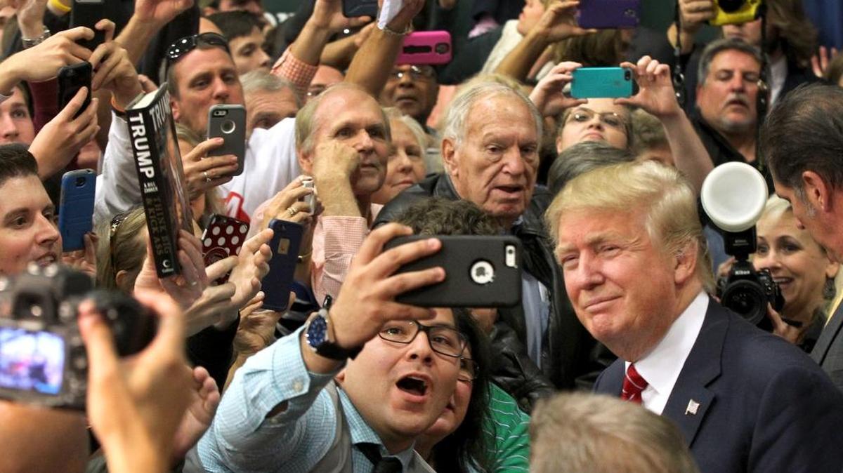 Republican presidential candidate Donald Trump poses for a fan after speaking Monday in Anderson, S.C.