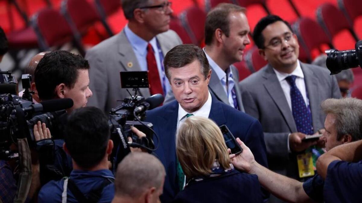 Trump Campaign Chairman Paul Manafort is surrounded by reporters on the floor of the Republican National Convention in Cleveland.