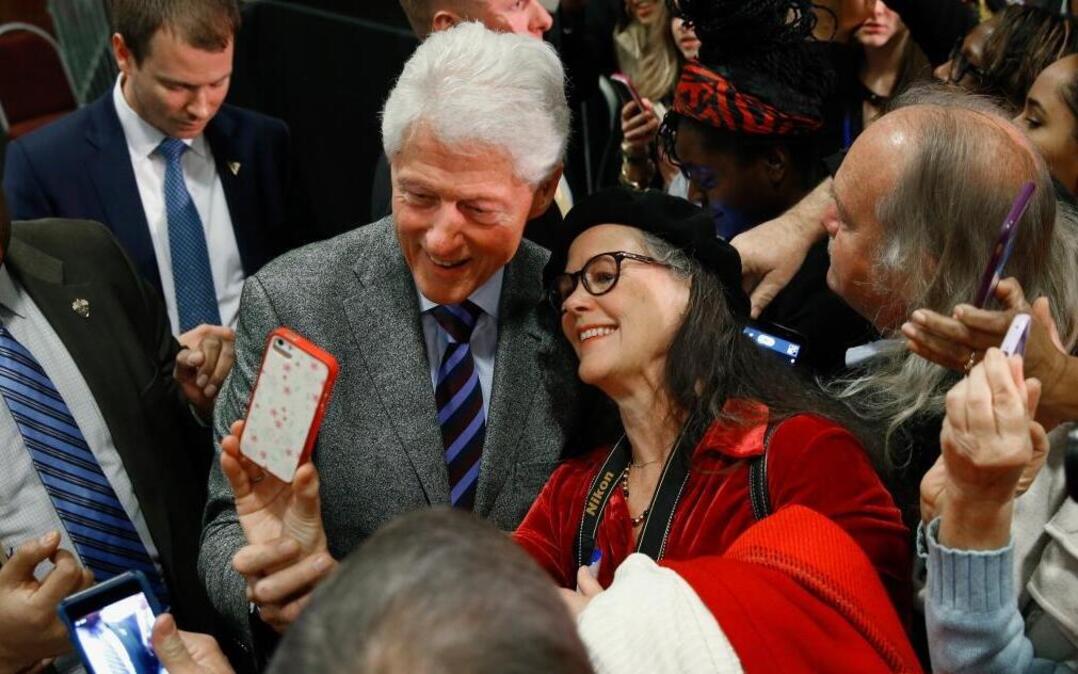 Former President Bill Clinton poses for photographs at the West End Community Development Center in Greenville, S.C., Tuesday, Feb. 16, 2016, during a campaign rally for his wife, Democratic presidential candidate Hillary Clinton.