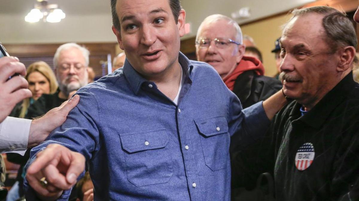 Sen. Ted Cruz, R-Texas talks to a reporter Tuesday after a campaign speech at the public library in Onawa, Iowa.