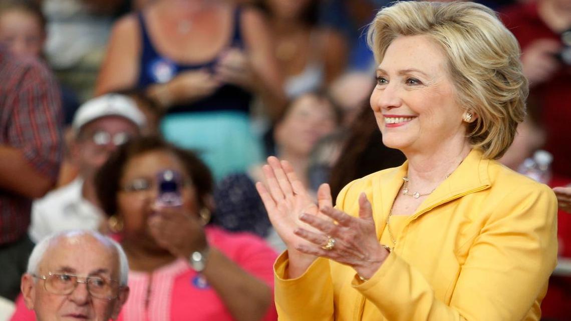
Hillary Clinton arrives to a cheering crowd during a campaign stop Tuesday in Nashua, N.H. In Washington, Democratic rival Lincoln Chafee criticized her 2002 Iraq war vote.
