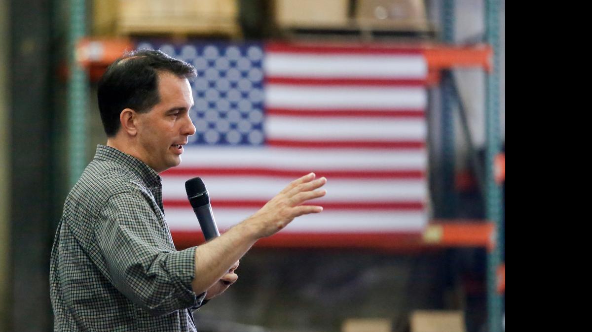 
Republican presidential candidate Wisconsin Gov. Scott Walker addresses an Iowa crowd. Walker Monday signed a tough law restricting abortions in his state.


