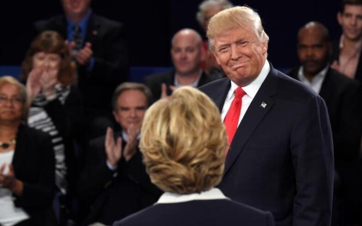 Republican presidential nominee Donald Trump, right, greets Democratic presidential nominee Hillary Clinton before the second presidential debate at Washington University in St. Louis, Sunday, Oct. 9, 2016.