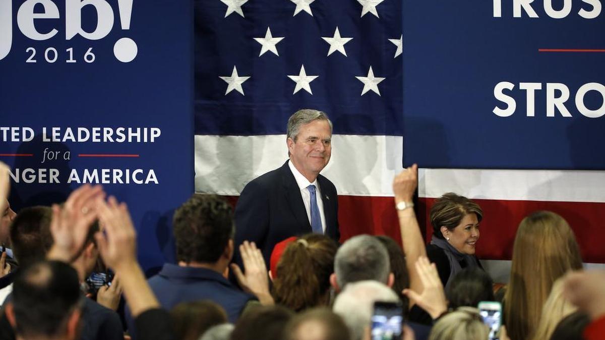 Former Florida Gov. Jeb Bush accompanied by his wife, Columba, moves to the stage at his South Carolina Republican presidential primary rally in Columbia, S.C., on Saturday, Feb. 20, 2016.