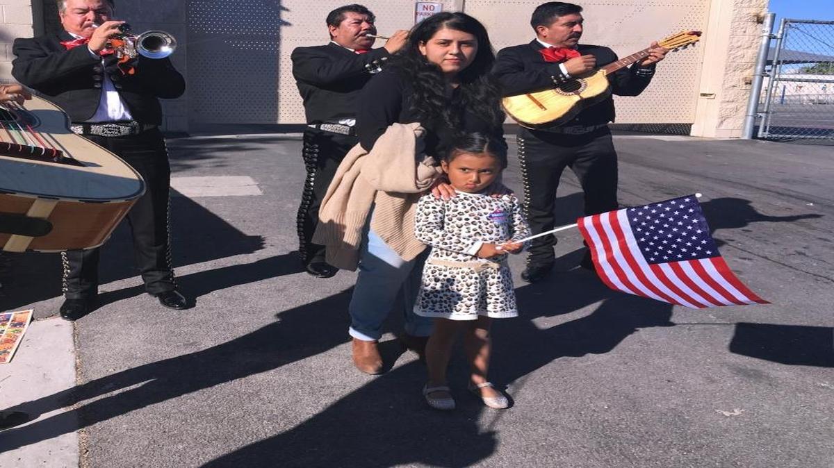 Jacqueline Lima, 20, walks with her four-year-old sister, Karla, holding an American flag, and gets serenaded by a mariachi group after Lima voted for the first time, Tuesday, Nov. 8, 2016, in Las Vegas. Immigrant advocates in Las Vegas worked to get more U.S.-born Latinos to the polls on Election Day as early voter numbers suggest a surge in Hispanic voters. Lima voted for Democrat Hillary Clinton.