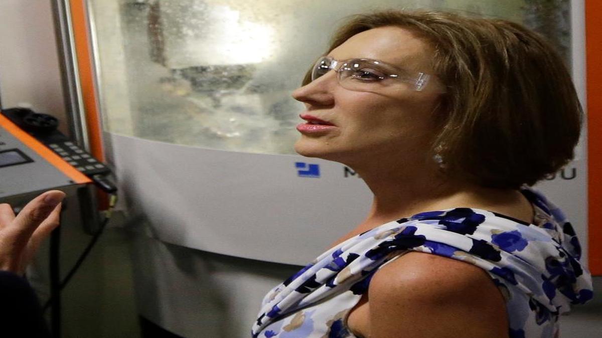 
Republican presidential candidate Carly Fiorina listens to Turbocam's Vice President of Engineering Rob Bujeaud as they tour the manufacturing company, July 6, 2015, on a campaign stop in Barrington, N.H. 
