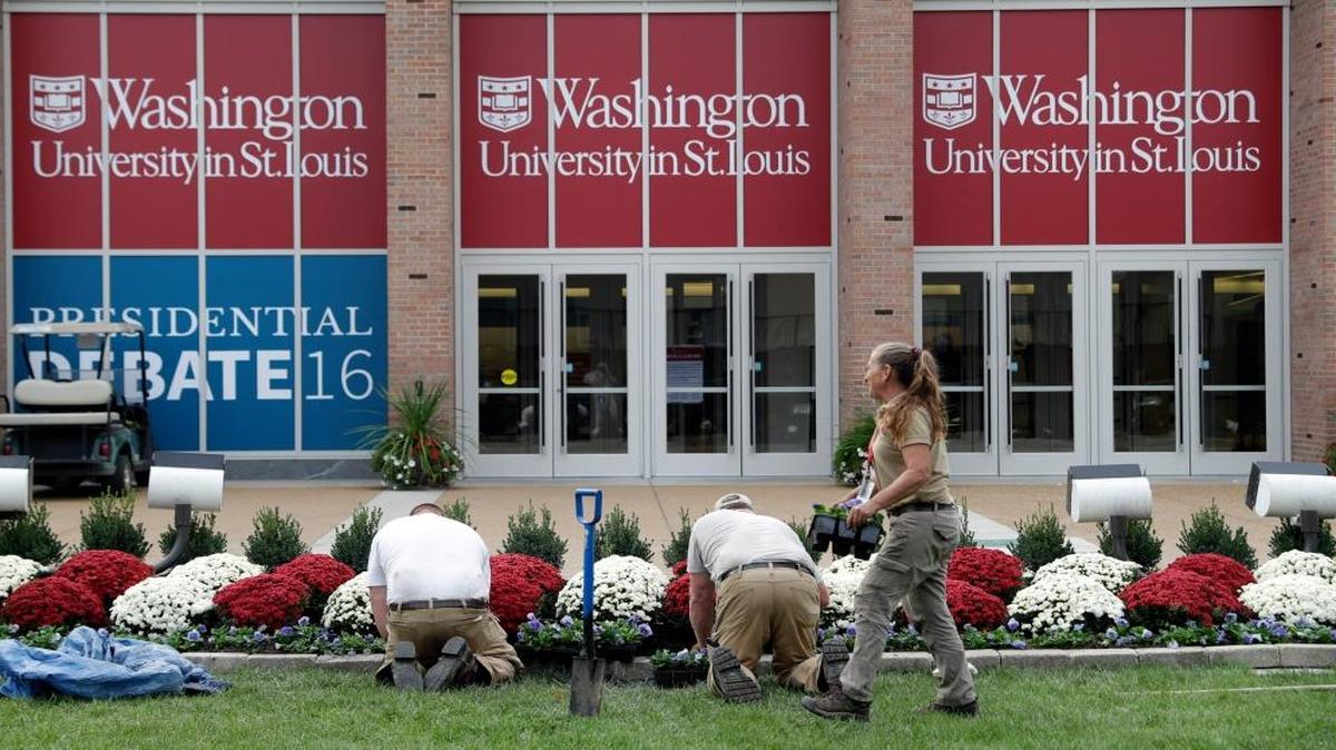 Workers plant flowers as preparations continue ahead of the second presidential debate at Washington University in St. Louis, Thursday, Oct. 6, 2016. The town hall debate between Republican presidential nominee Donald Trump and Democratic presidential nominee Hillary Clinton is set for this Sunday.
