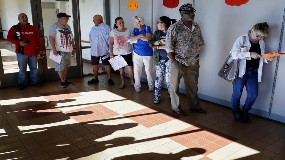 People wait in line for early voting Saturday, Oct. 22, 2016, in Las Vegas.