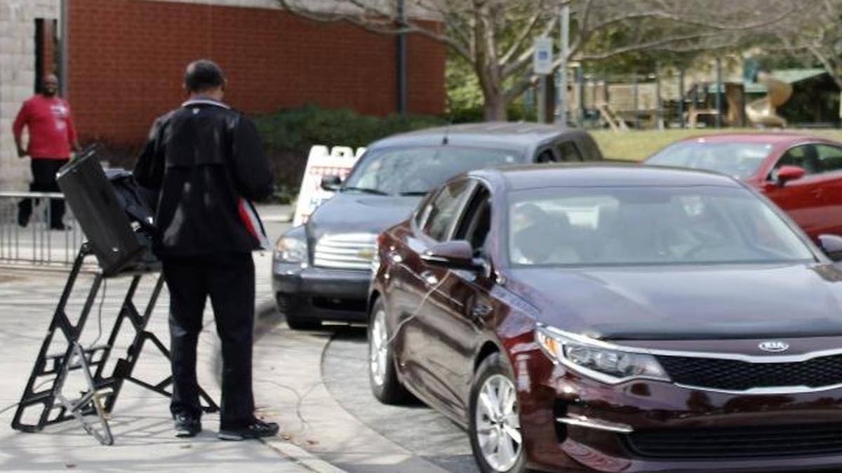 Voters at Brown Recreation Center in Greensboro, North Carolina, take advantage of curbside voting on Thursday, Oct. 27, 2016, which marked the first day of early voting in Guilford County.