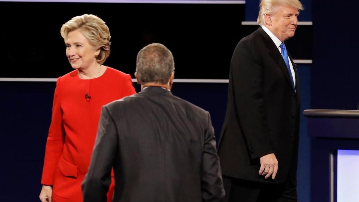 Democratic presidential nominee Hillary Clinton and Republican presidential nominee Donald Trump walk their separate ways after the presidential debate at Hofstra University in Hempstead, N.Y., Monday, Sept. 26, 2016.
