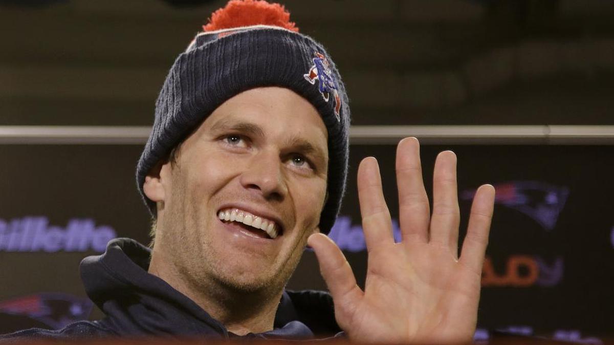 In this Wednesday, Dec. 16, 2015, file photo, New England Patriots quarterback Tom Brady smiles and waves goodbye to the media after being asked by a reporter about his supposed friendship with Republican presidential hopeful Donald Trump at the NFL football team's facility, in Foxborough, Mass.
