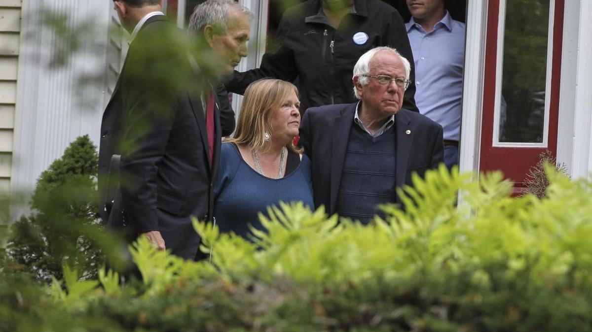 Democratic presidential candidate, Sen. Bernie Sanders, I-Vt., with wife Jane by his side, walks out of his home to speak during a news conference Sunday, June 12, 2016, in Burlington, Vt.